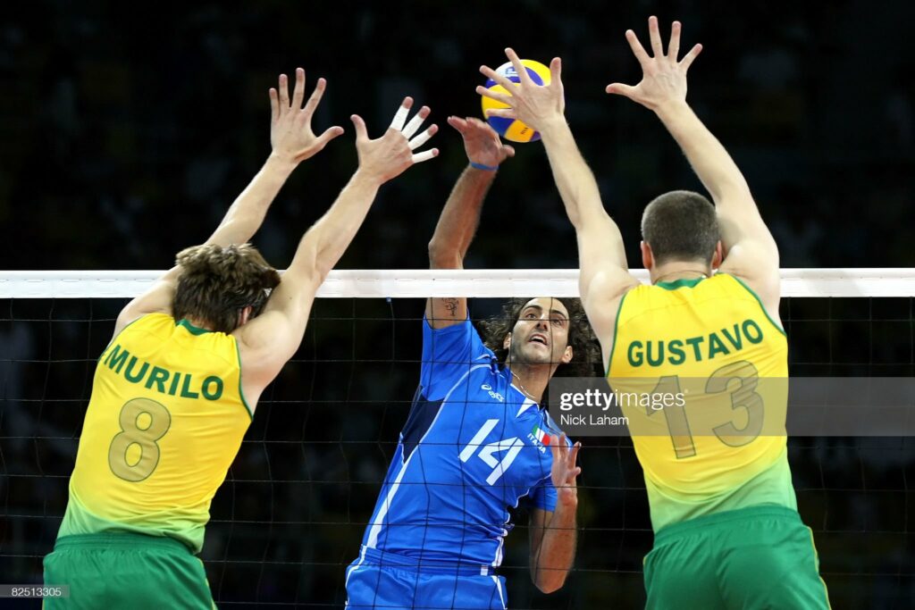 BEIJING - AUGUST 22:  Alessandro Fei #14 of Italy goes up for a spike over Murilo Endres #8 and Gustavo Endres #13 of Brazil during the semifinal volleyball game at the Capital Indoor Stadium on Day 14 of the Beijing 2008 Olympic Games on August 22, 2008 in Beijing, China.  (Photo by Nick Laham/Getty Images)