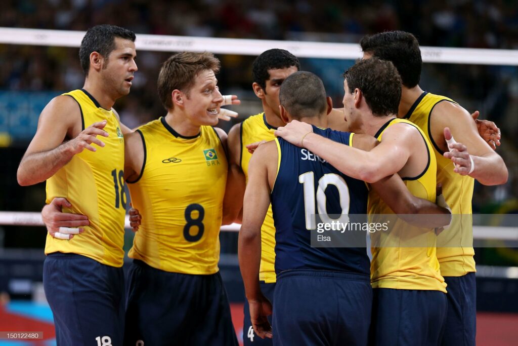 LONDON, ENGLAND - AUGUST 10:  Dante Amaral #18, Murilo Endres #8  and Sergio Santos #10 of Brazil react after a point against Italy during the Men's Volleyball Semifinals on Day 14 of the London 2012 Olympic Games at Earls Court on August 10, 2012 in London, England.  (Photo by Elsa/Getty Images)