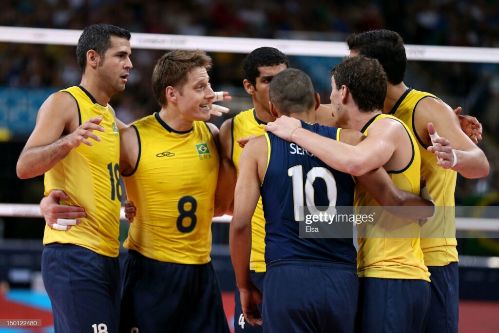 LONDON, ENGLAND - AUGUST 10: Dante Amaral #18, Murilo Endres #8 and Sergio Santos #10 of Brazil react after a point against Italy during the Men's Volleyball Semifinals on Day 14 of the London 2012 Olympic Games at Earls Court on August 10, 2012 in London, England. (Photo by Elsa/Getty Images)